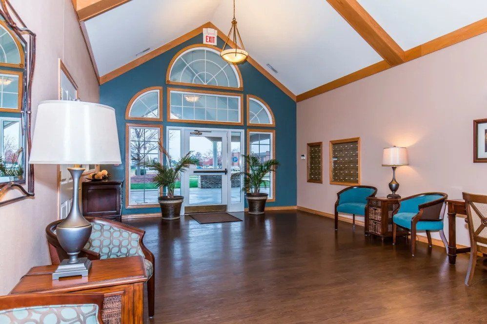 A well-lit lobby with comfortable seating and decorative plants.