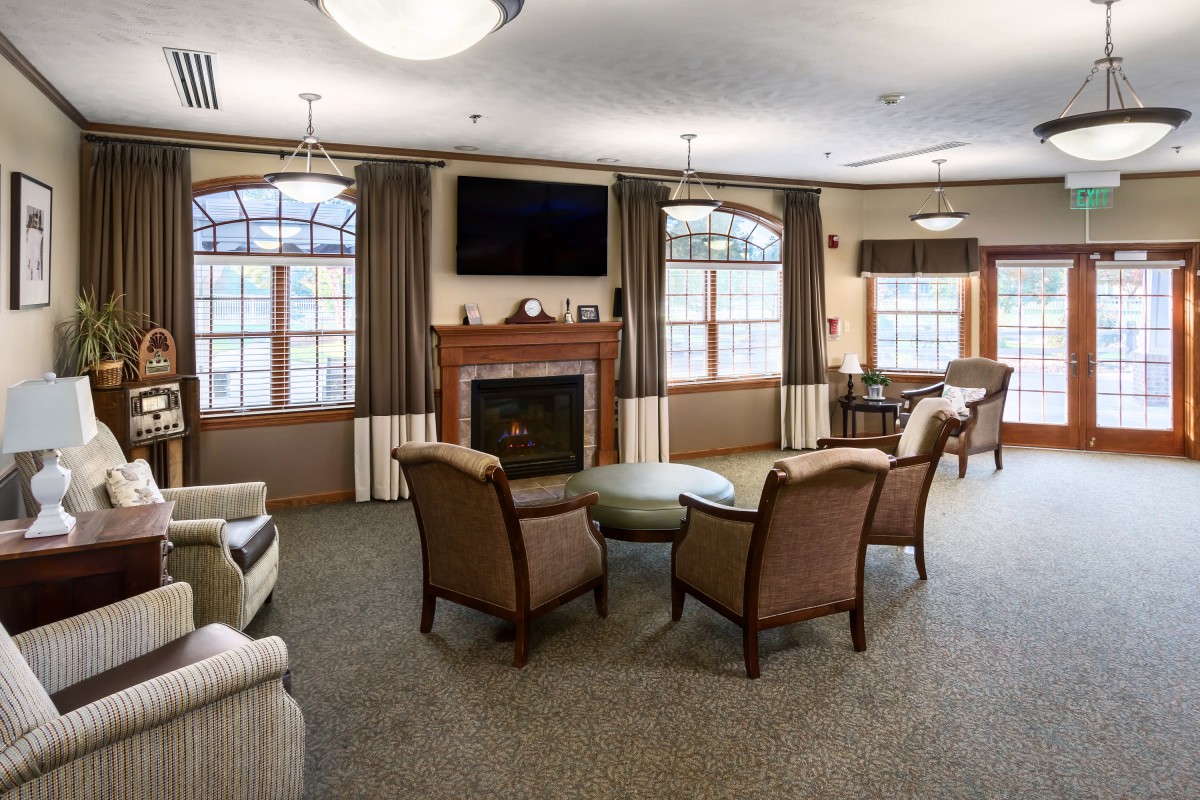 A cozy living room with a fireplace, television, and comfortable seating.