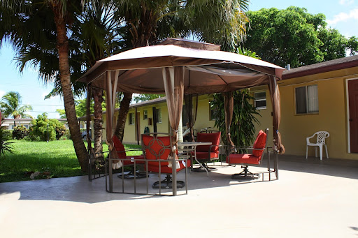 A cozy gazebo with comfortable red seating, perfect for enjoying the outdoors.