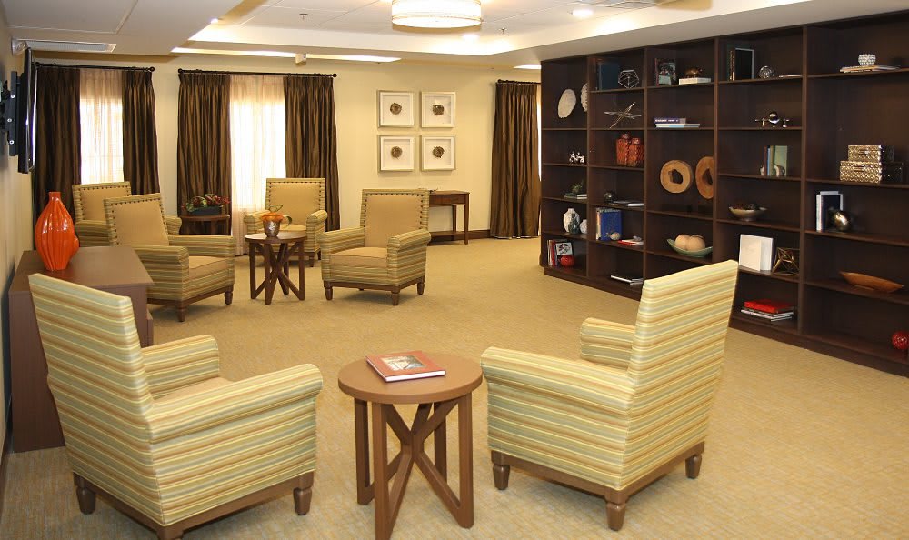 A cozy lounge area with comfortable seating and a stylish bookshelf.