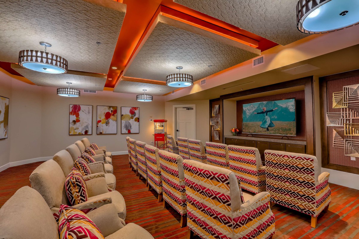 A cozy home theater with colorful seating and vibrant artwork.