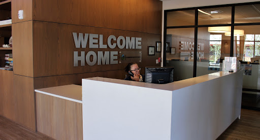 A warm and inviting reception area featuring a 'Welcome Home' sign.