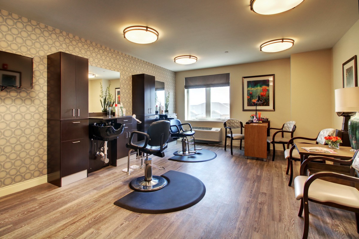 A modern salon interior with styling chairs, mirrors, and elegant lighting.