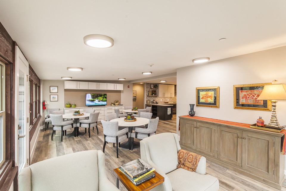 A modern living and dining area with neutral tones and stylish furniture.