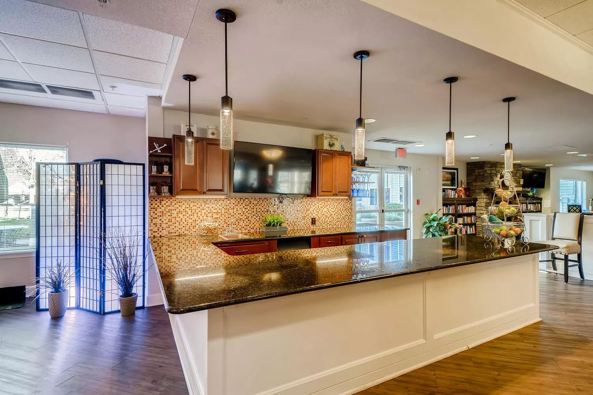 A modern kitchen with a spacious countertop and stylish pendant lighting.