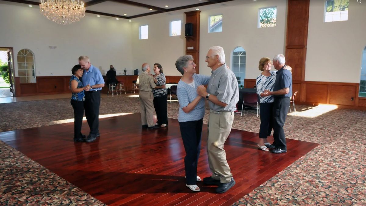 Seniors enjoy dancing together in a community event.