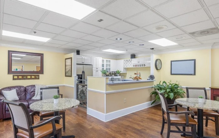 A modern reception area with comfortable seating and decorative plants.