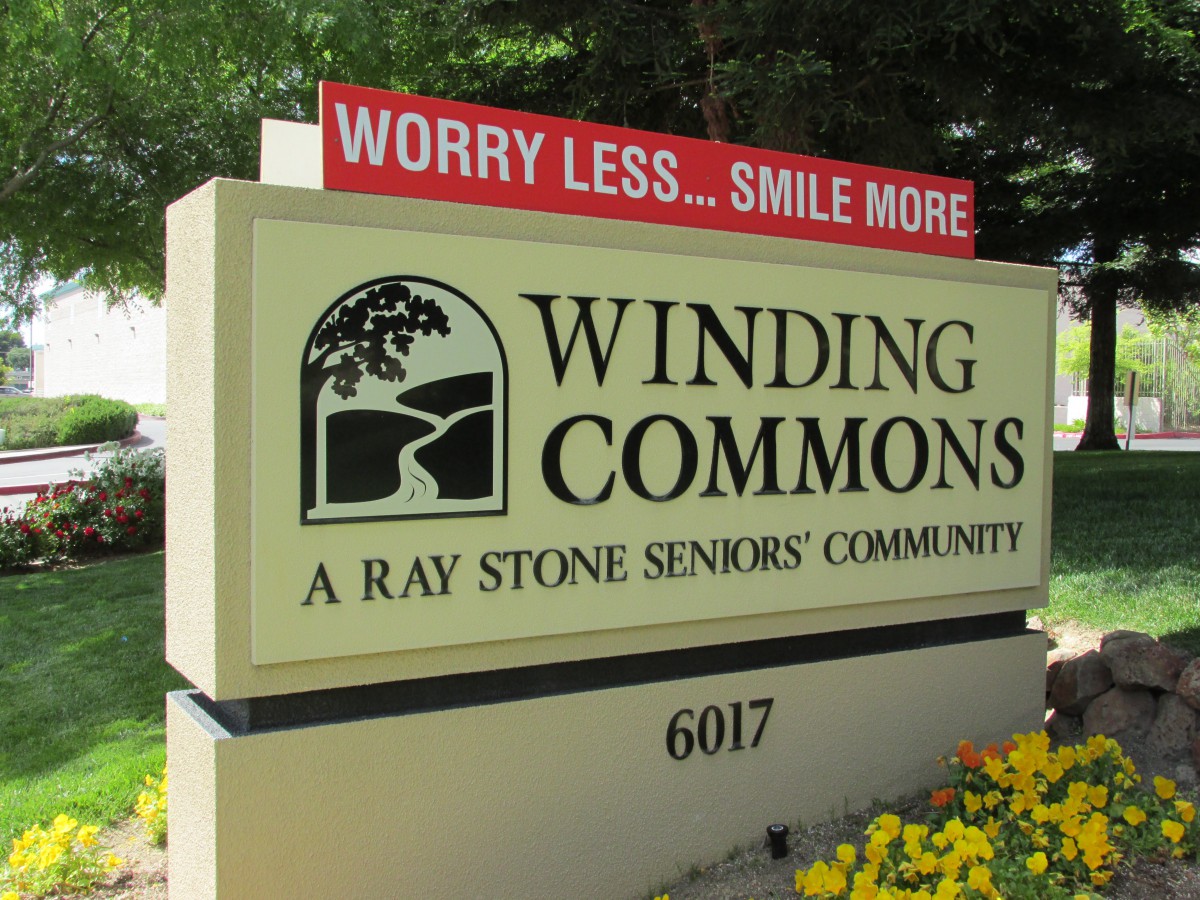 Sign for Winding Commons, a Ray Stone seniors' community, encouraging residents to worry less and smile more.