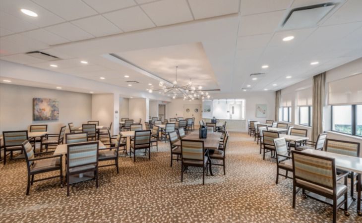 An elegant dining room with neatly arranged tables and chairs.
