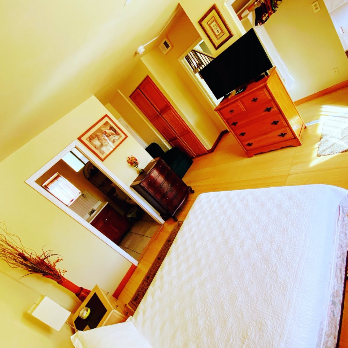 Cozy bedroom with stylish furniture and a large television.