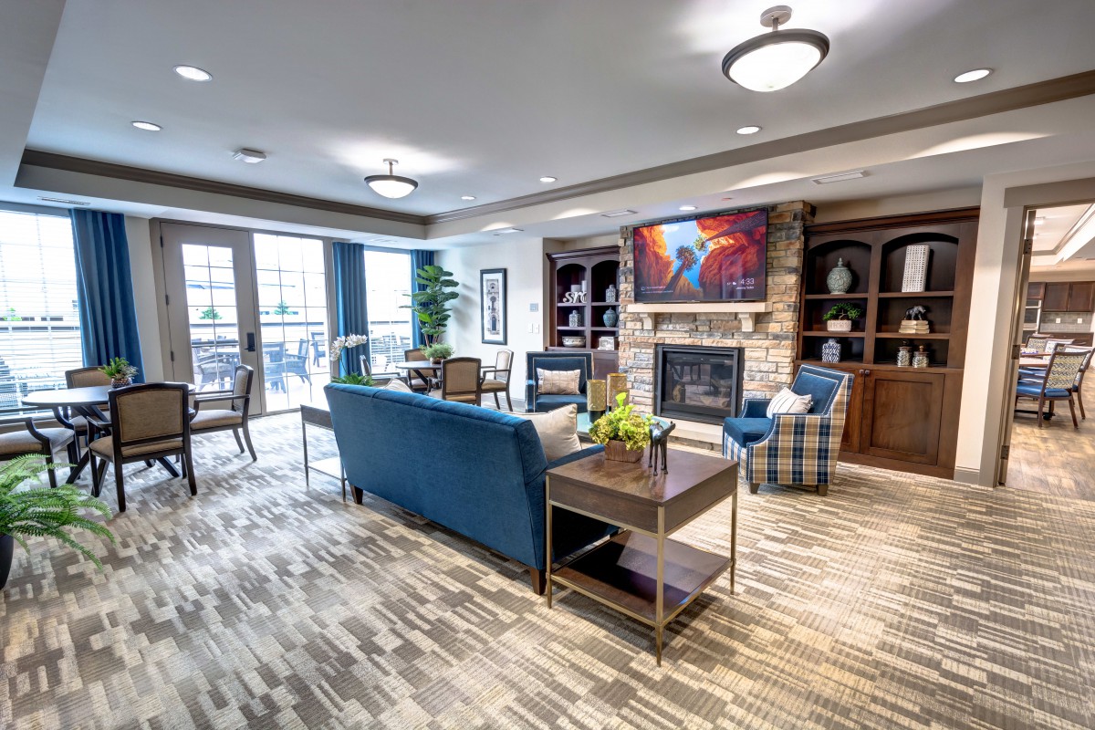 A modern living room with comfortable seating and a cozy fireplace.