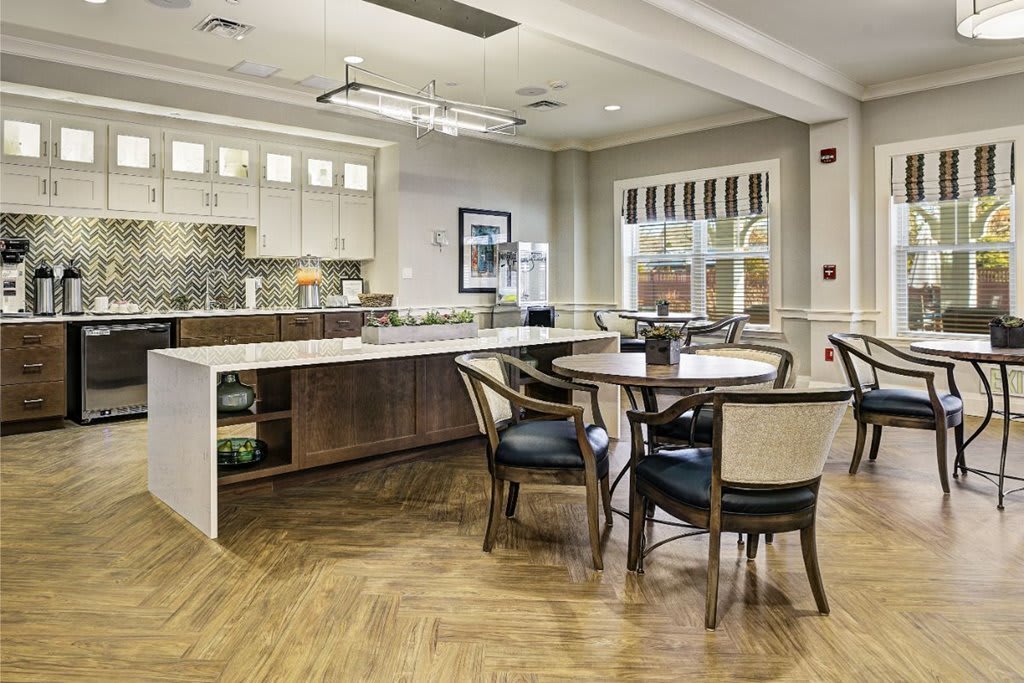 A contemporary kitchen and dining area with an open layout and wood flooring.