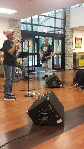 A lively performance by a local band in an indoor venue, engaging the audience with music.