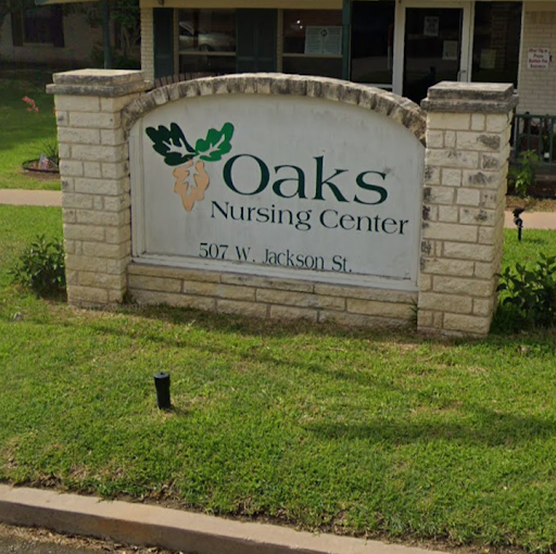 The sign for Oaks Nursing Center, indicating a healthcare facility.