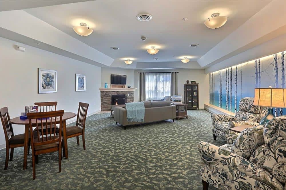 A spacious living room with a comfortable seating area and large windows.