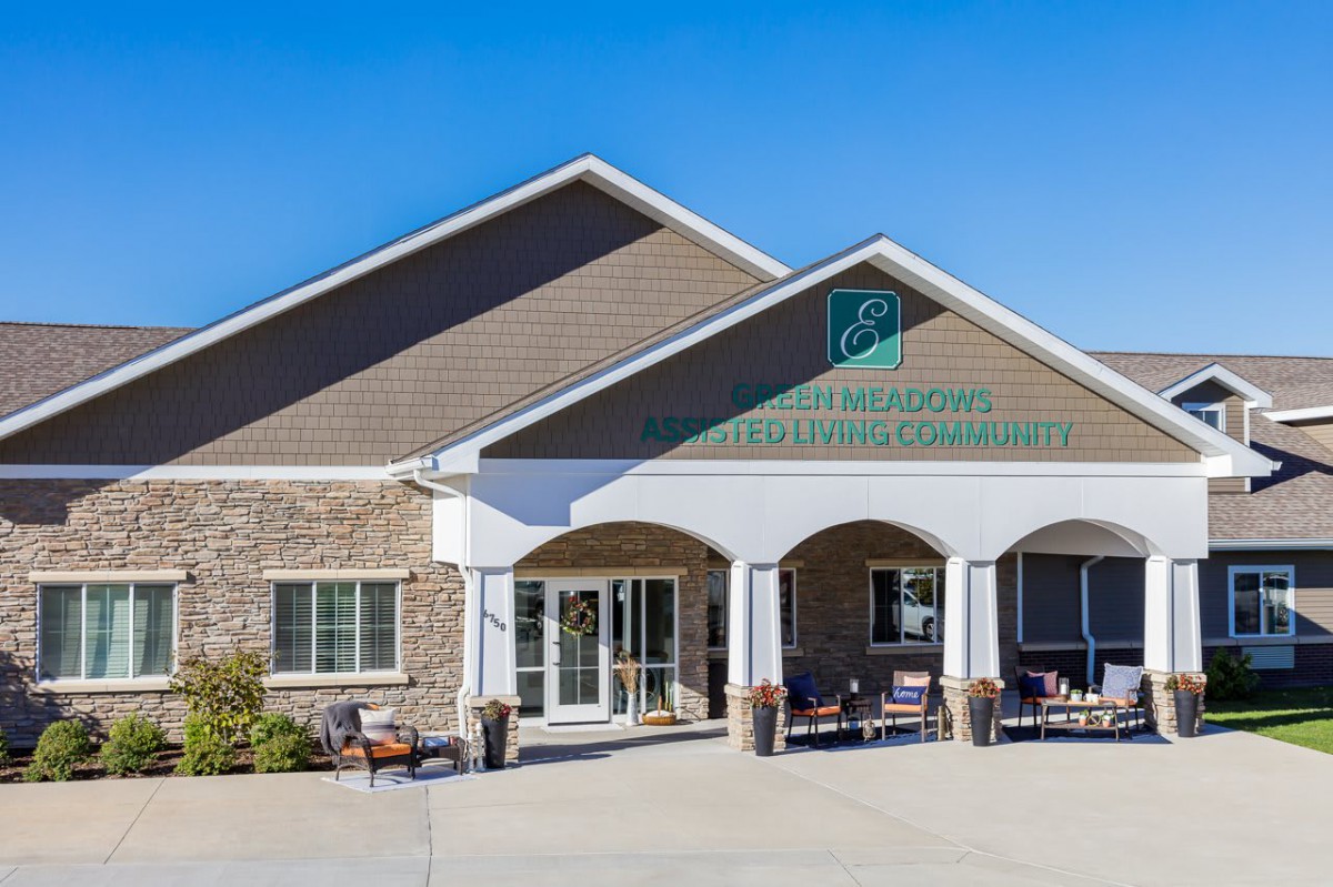 A commercial building with a welcoming entrance under a clear blue sky.