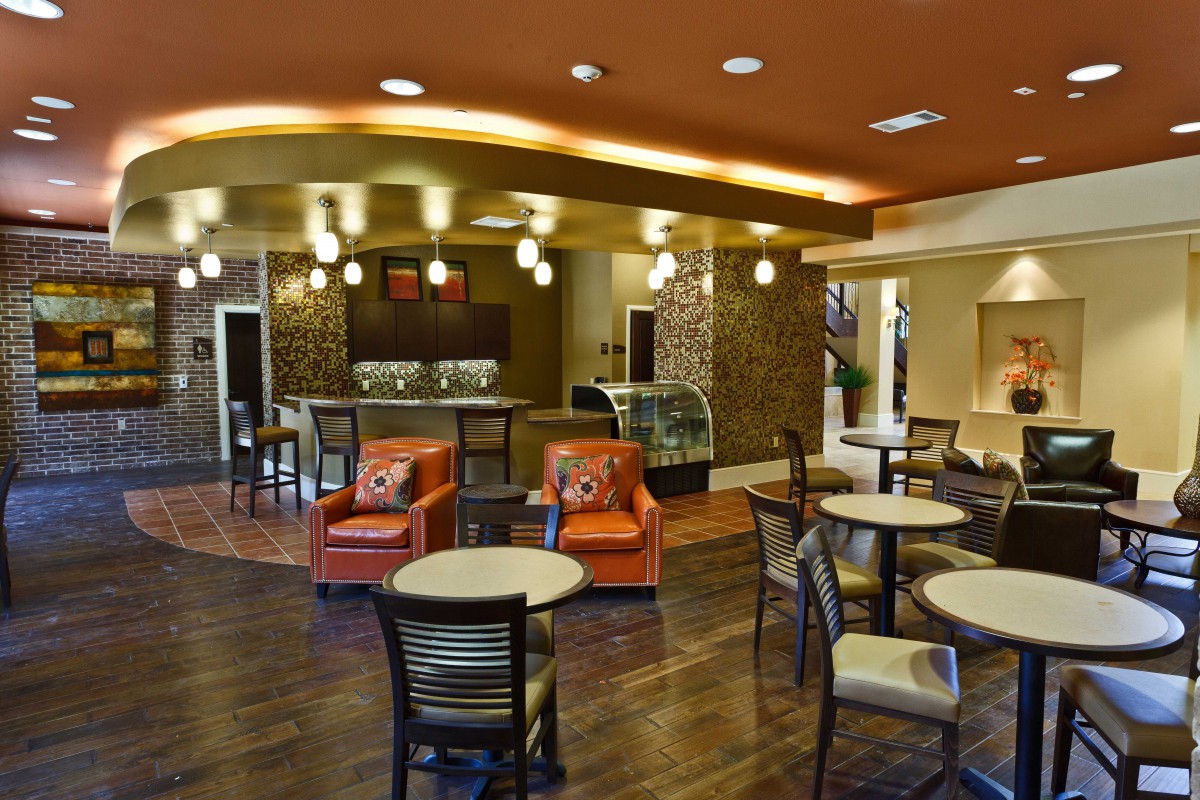 A modern cafe interior with comfortable seating and stylish decor.