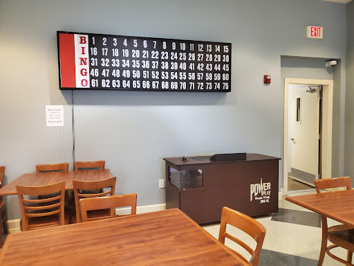 A cozy bingo hall featuring a large bingo board and seating for players.