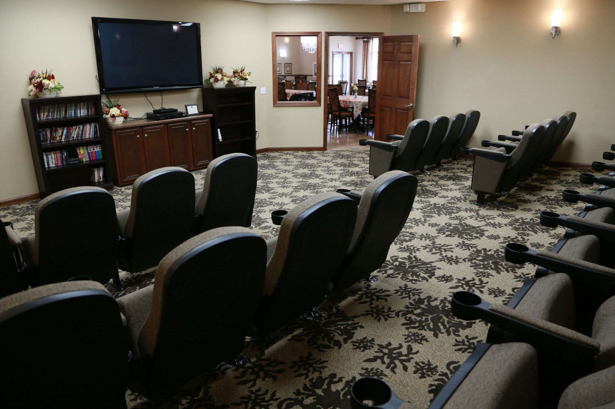 A cozy home theater setup with comfortable seating and a large screen for viewing.