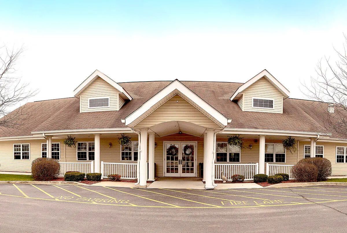 A single-story building with a sloped roof and large entrance.