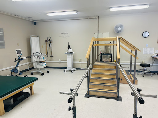 A well-equipped physical therapy room featuring a set of training stairs and various rehabilitation tools.