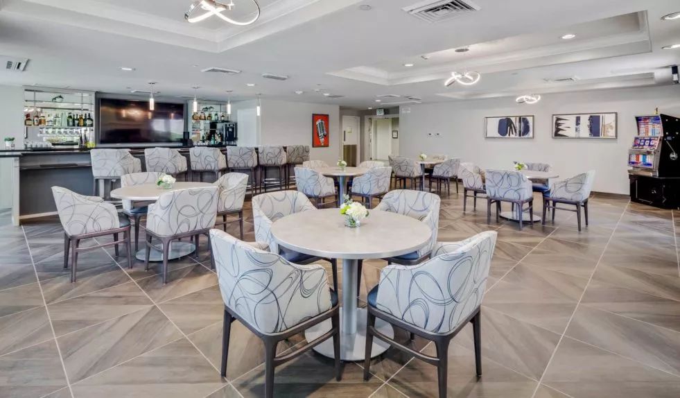 A modern dining area with elegantly arranged tables and chairs.
