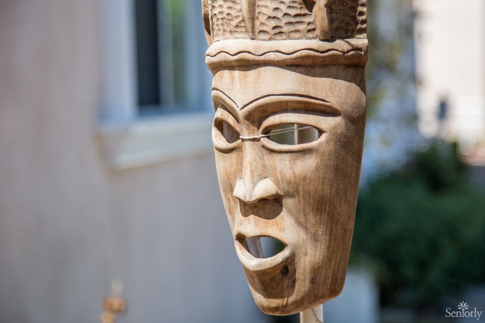 A close-up of a wooden mask showcasing intricate craftsmanship and cultural artistry.