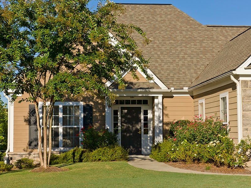 A suburban house with a well-maintained lawn and garden.