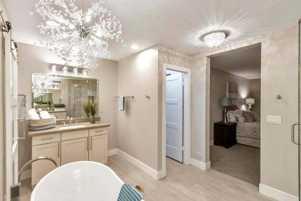 A modern bathroom with elegant lighting and a stylish vanity setup.