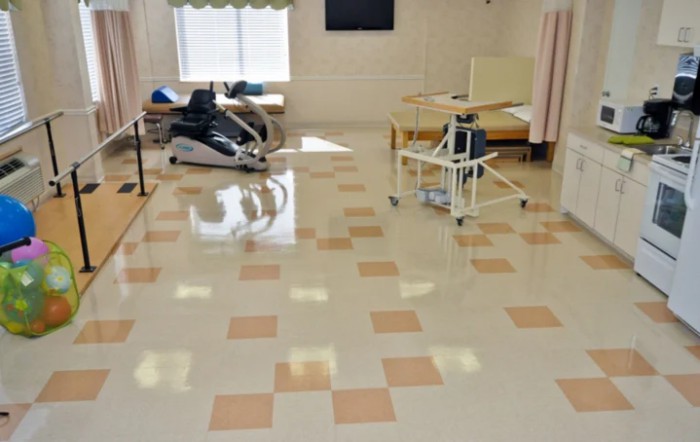 A hospital rehabilitation room with exercise and medical equipment.