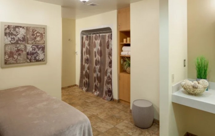 A cozy room with curtains and neatly organized shelves.