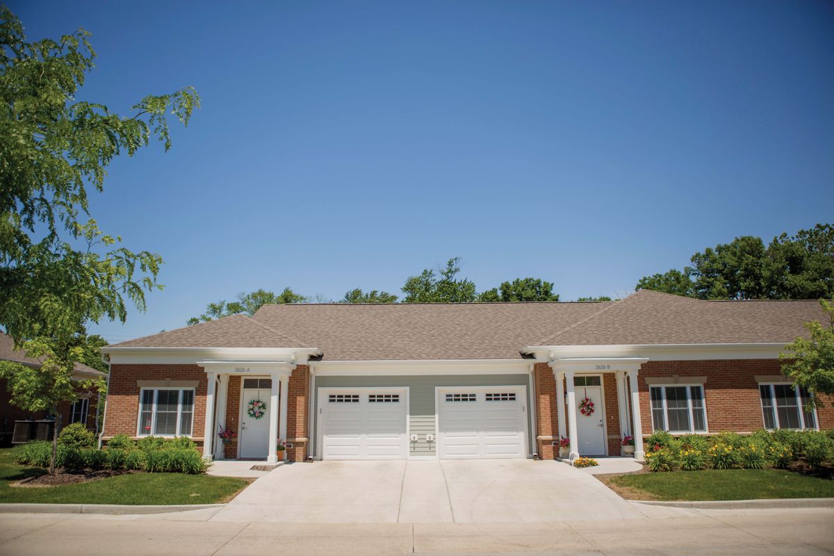A suburban duplex with two garages and a shared driveway.