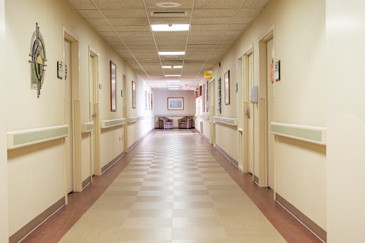 A well-lit corridor in a hospital, showcasing the typical layout and design of healthcare facilities.
