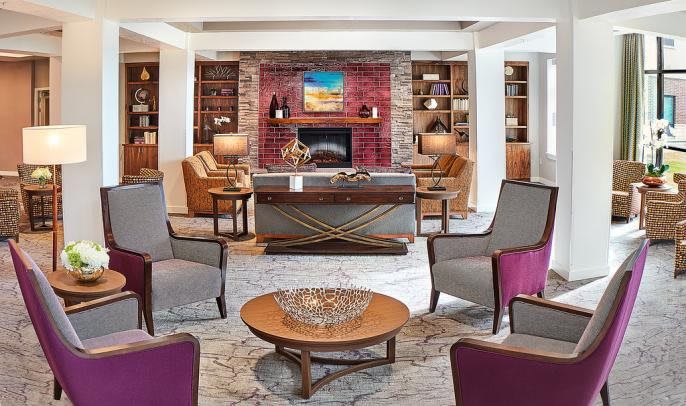A cozy living room with a fireplace and comfortable seating arrangements.