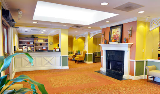 A welcoming lobby area featuring a reception desk and a cozy seating nook by the fireplace.
