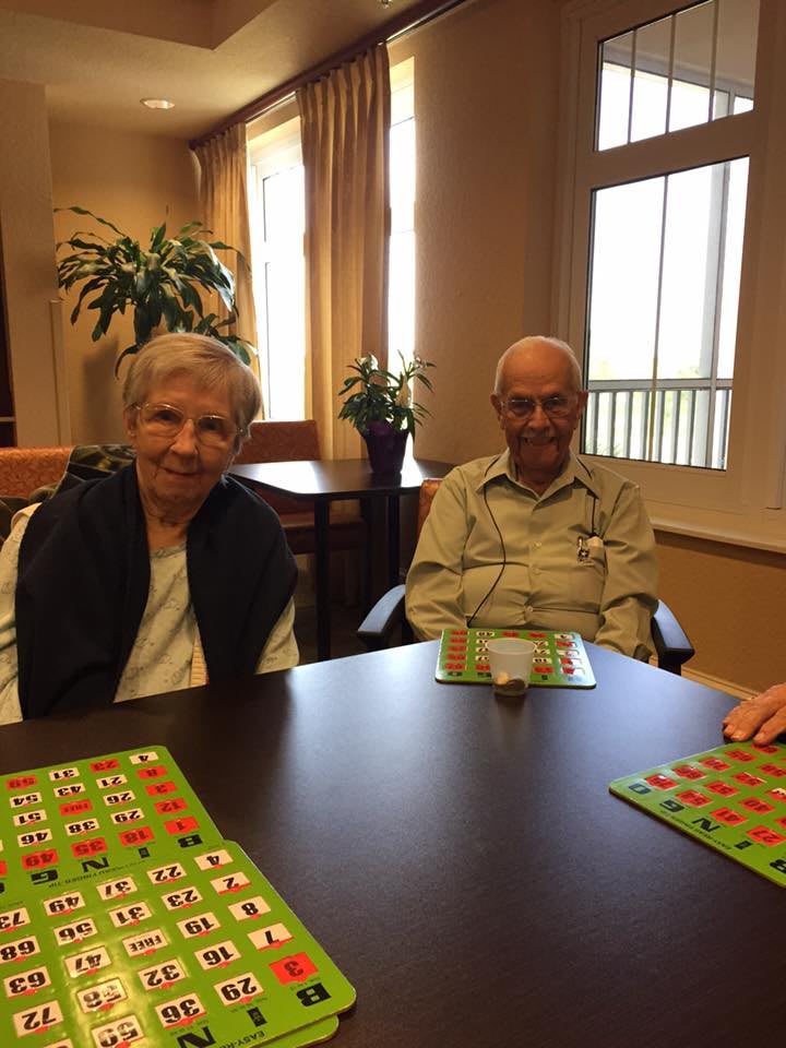 Elderly individuals enjoying a game of bingo together in a community setting.