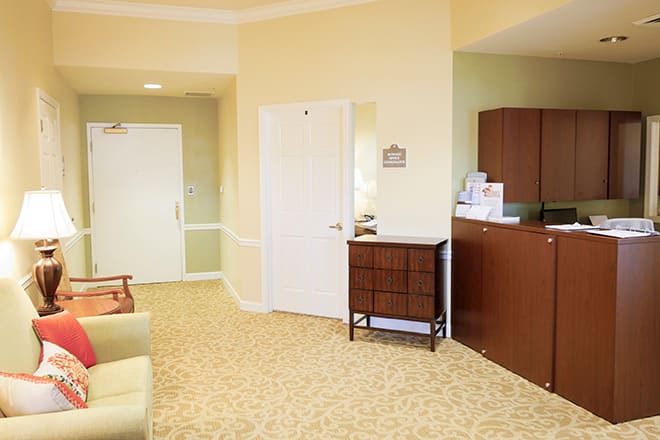 A well-lit waiting room with a reception desk and comfortable seating.