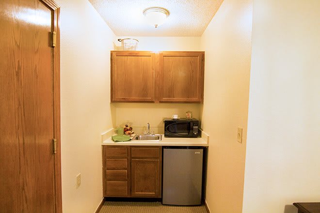 Compact kitchen area with wooden cabinets and essential appliances.