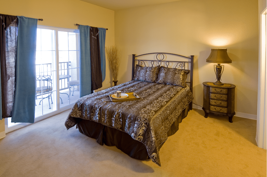 A cozy bedroom with a nicely made bed and elegant furnishings.