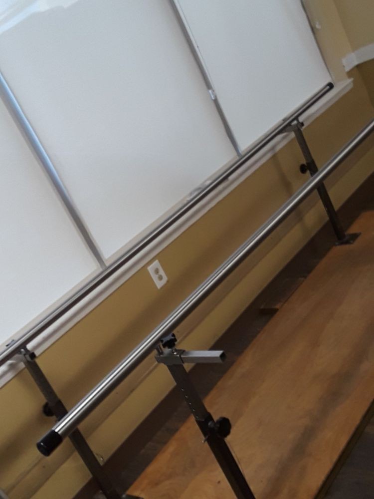 A set of parallel bars commonly used in rehabilitation or therapy settings.