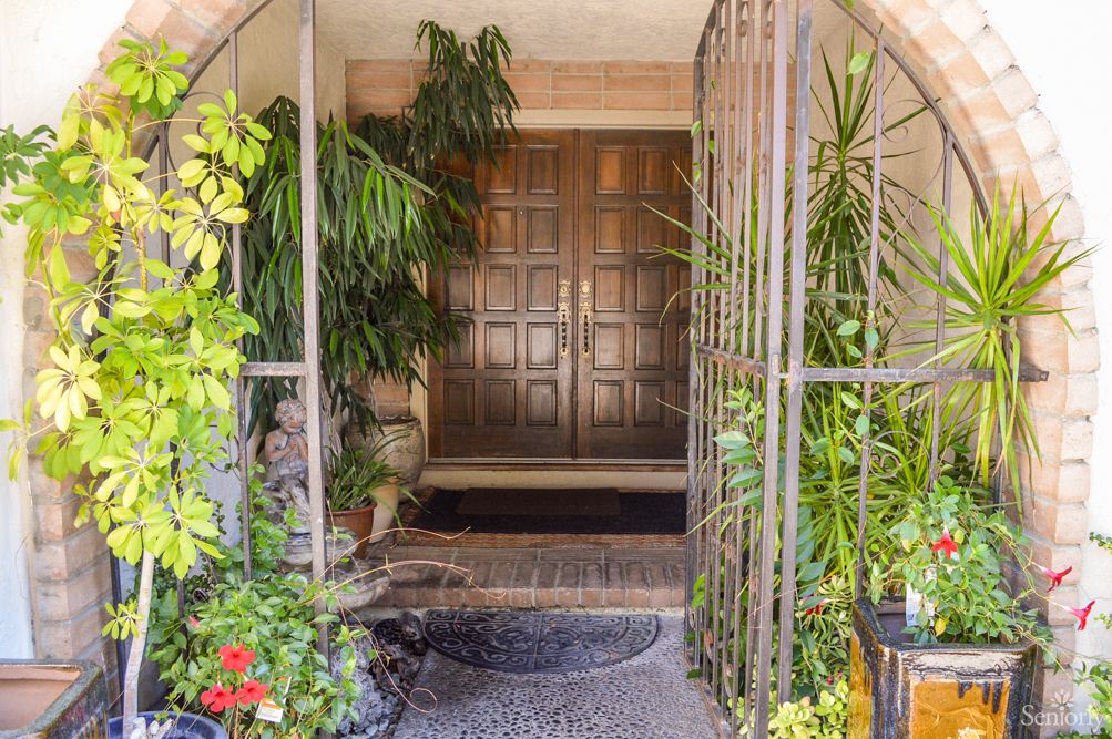 A welcoming entrance surrounded by lush greenery.