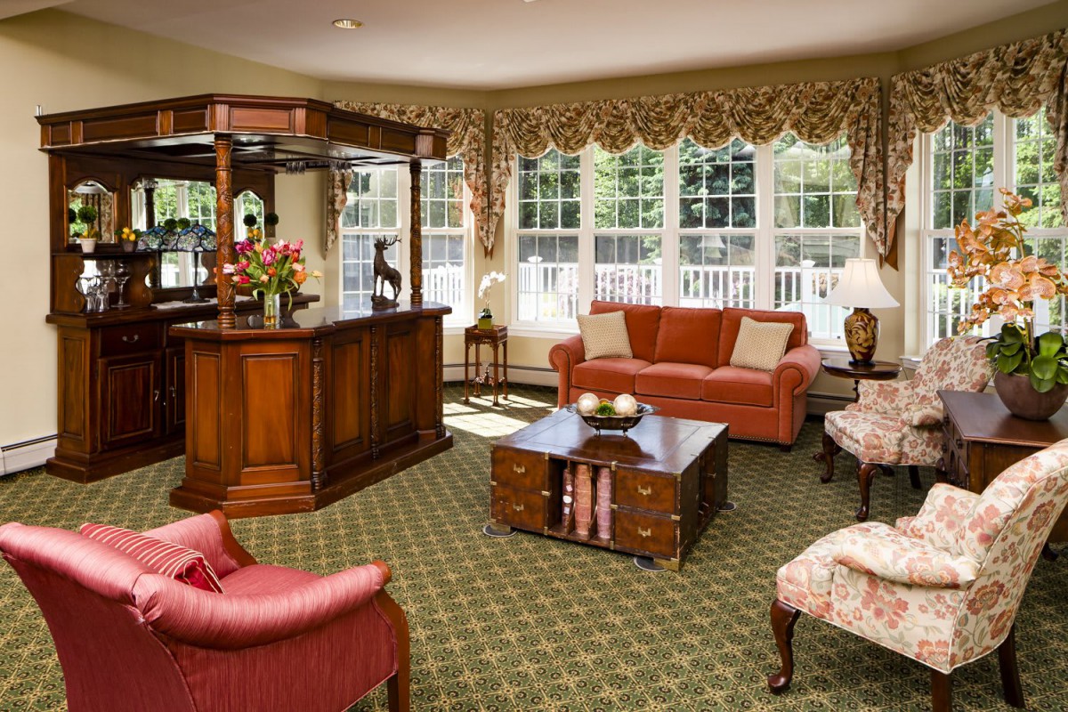 A cozy living room with elegant furniture and large windows.
