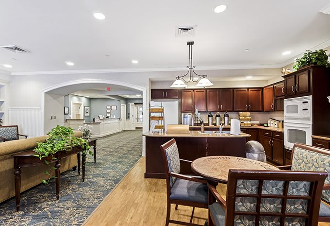 A modern kitchen and dining area with elegant furnishings and lighting.
