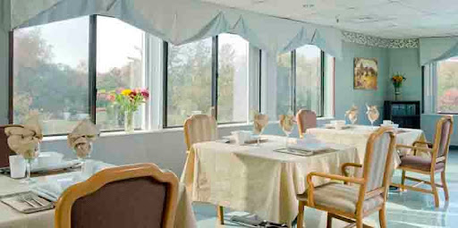 A bright and elegant dining area with tables set near large windows.