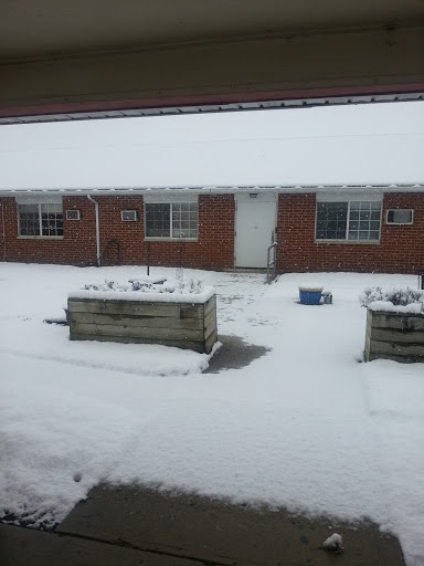 A residential building blanketed in snow during winter.