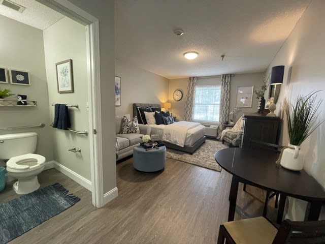 A modern apartment bedroom featuring stylish furnishings and decor.