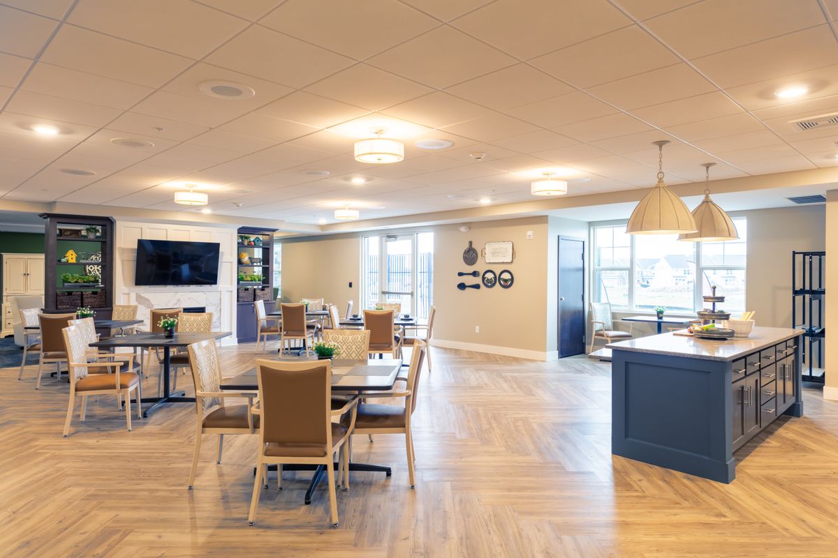 A modern and spacious dining area with tables and chairs, featuring a sleek design and ample lighting.