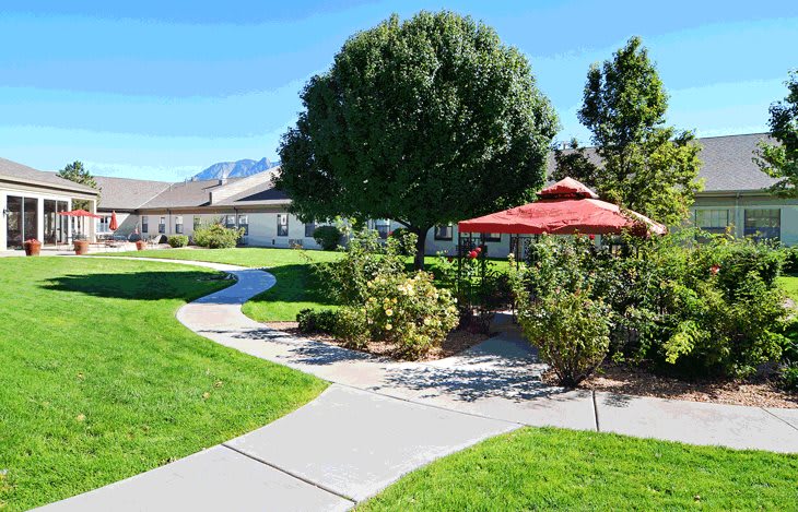 A beautifully landscaped garden with a winding pathway and a gazebo.