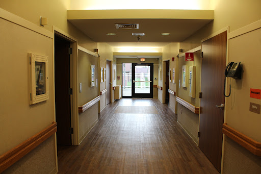 A view down a well-lit hallway in a healthcare facility.