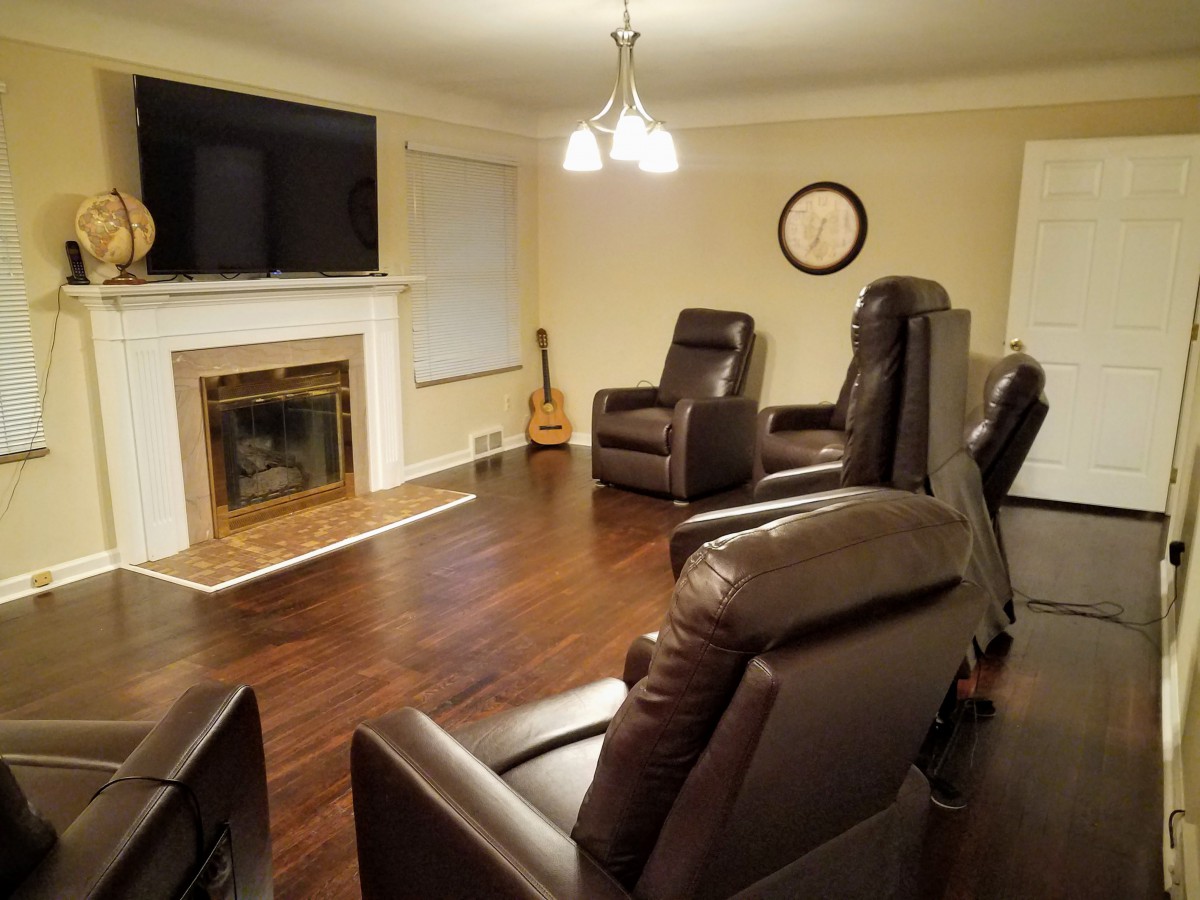 Cozy living room with recliner chairs and a fireplace.